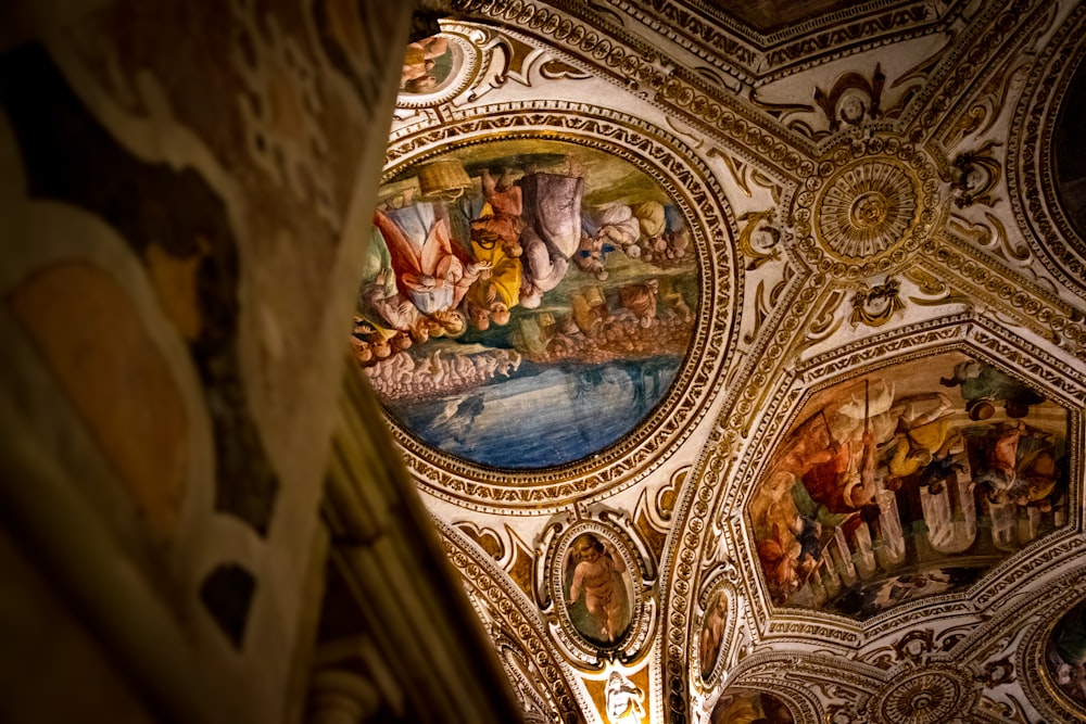 the ceiling of a building with paintings on it