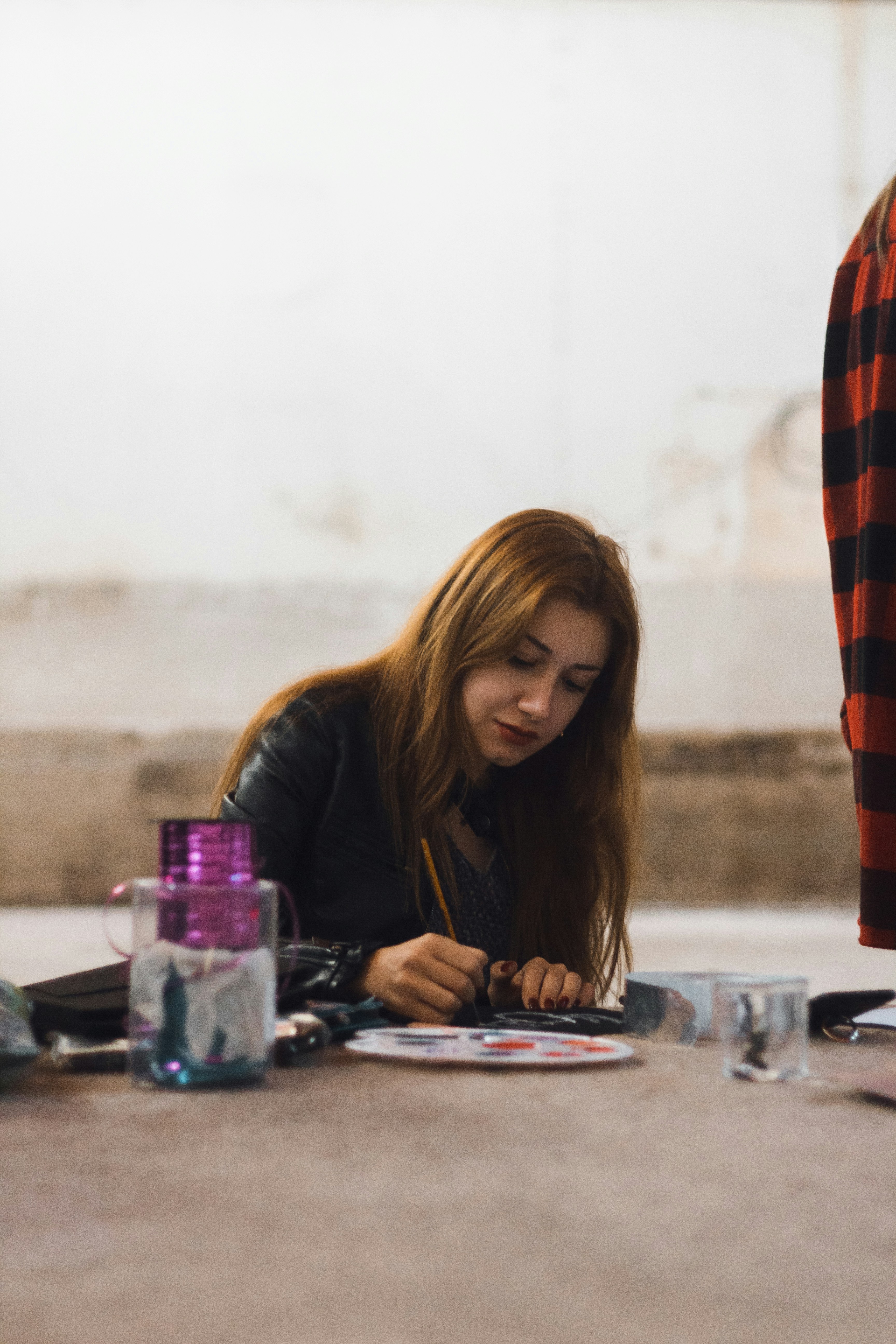 a woman is writing on a piece of paper