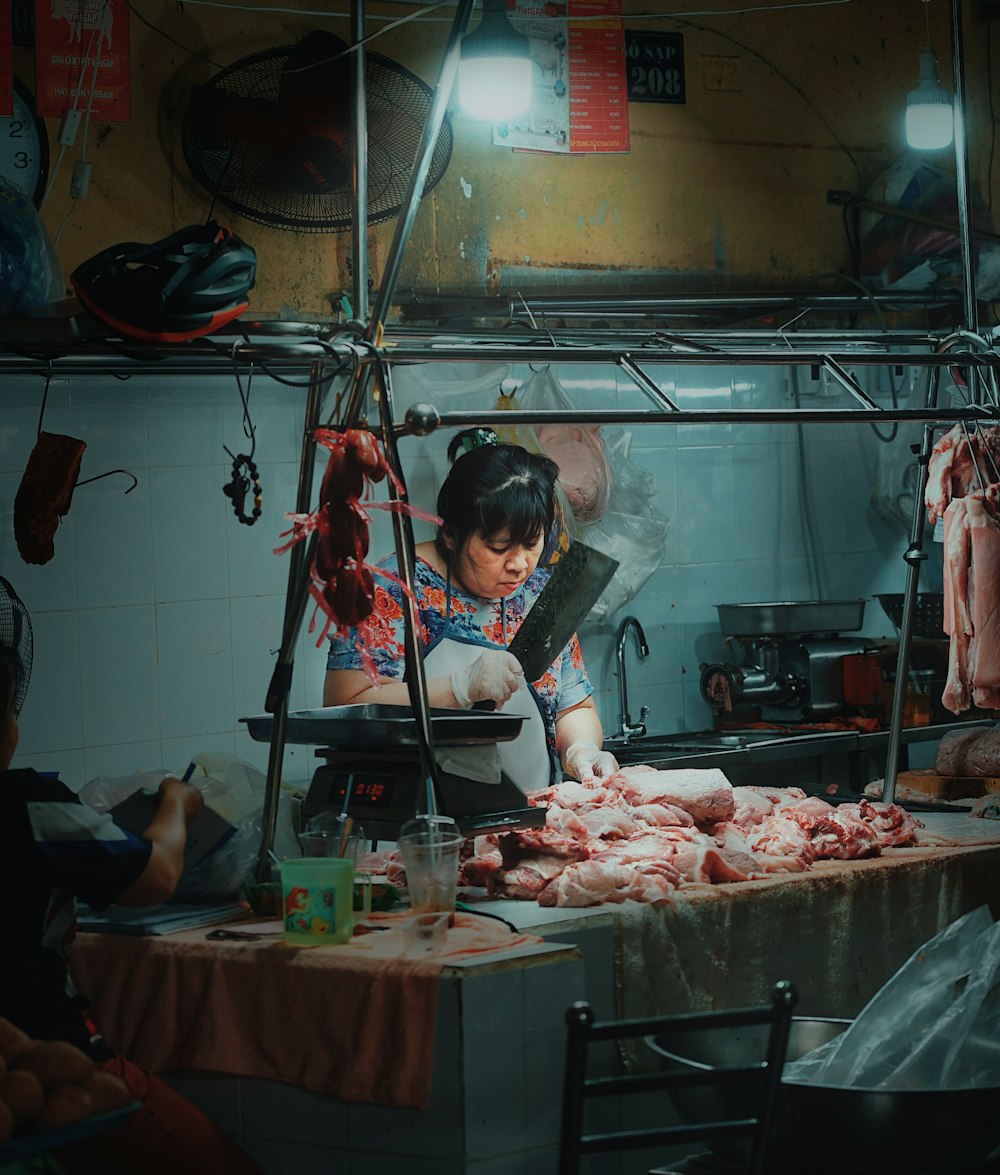 a woman standing in a kitchen preparing food