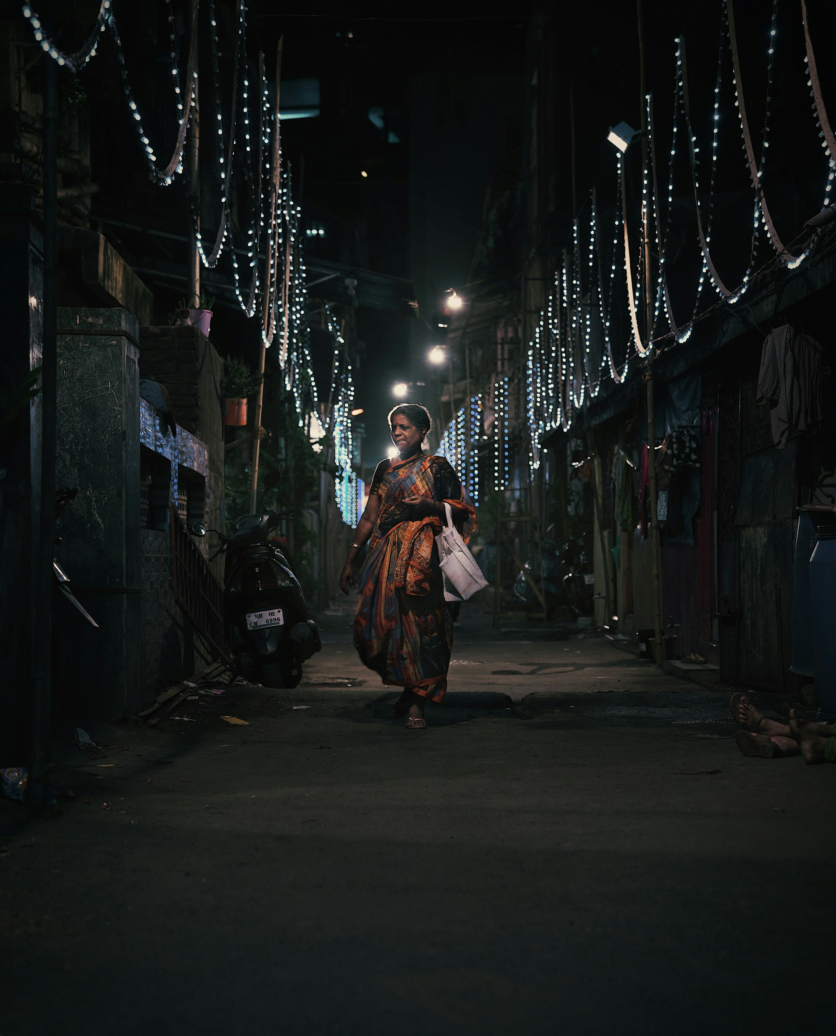 a woman walking down a street at night