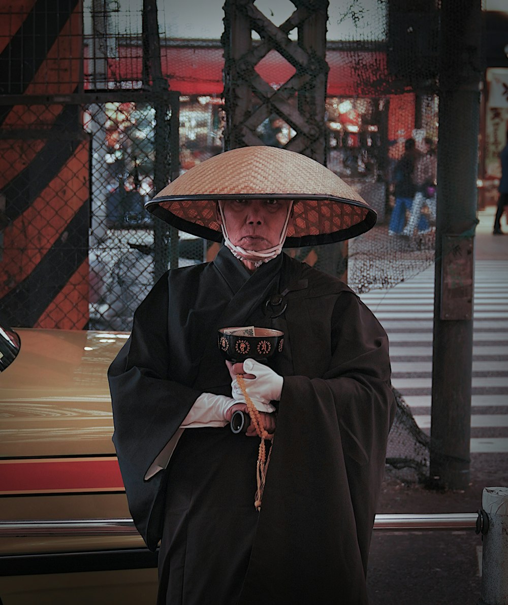 a person wearing a hat and holding a cell phone