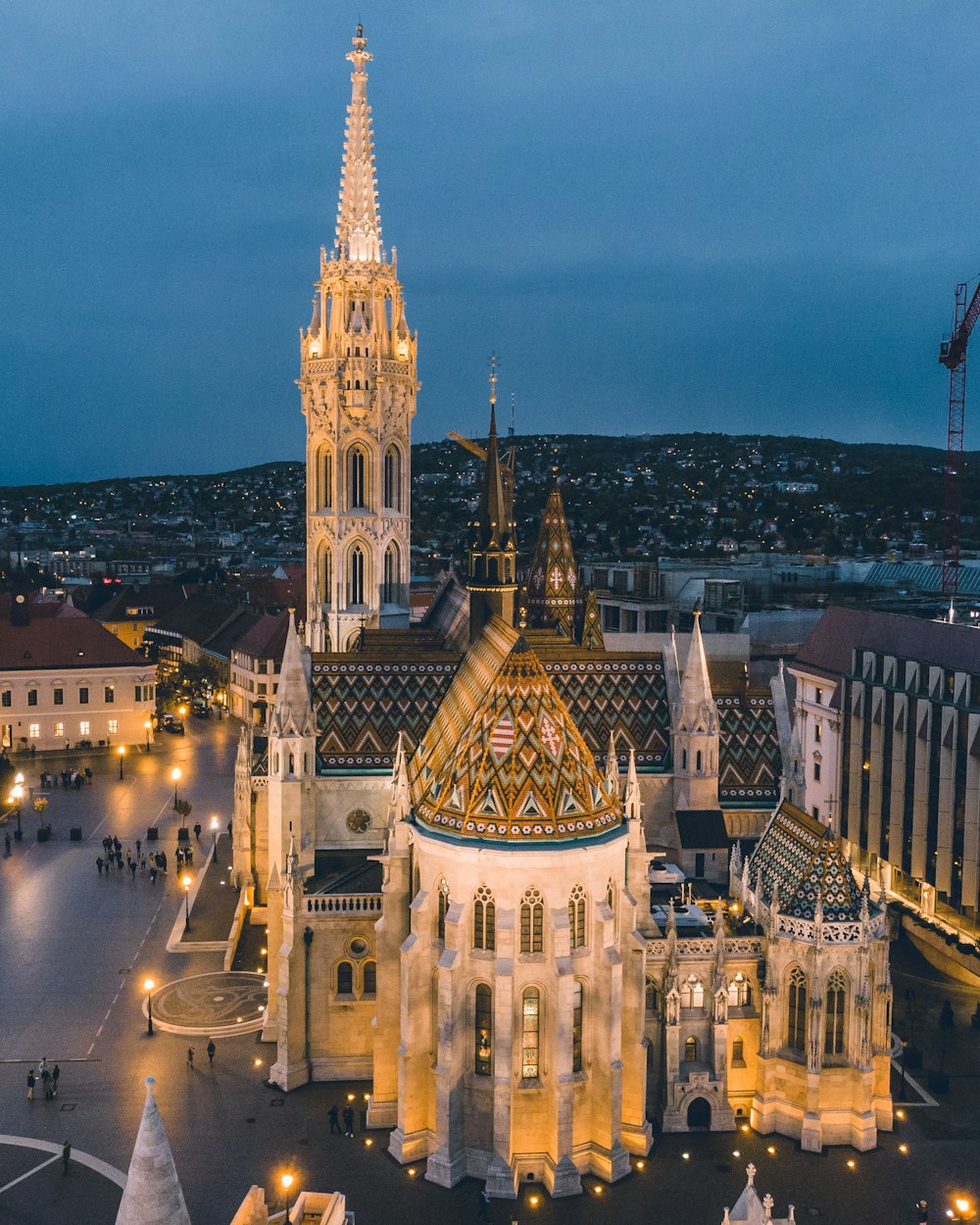 an aerial view of a large cathedral lit up at night