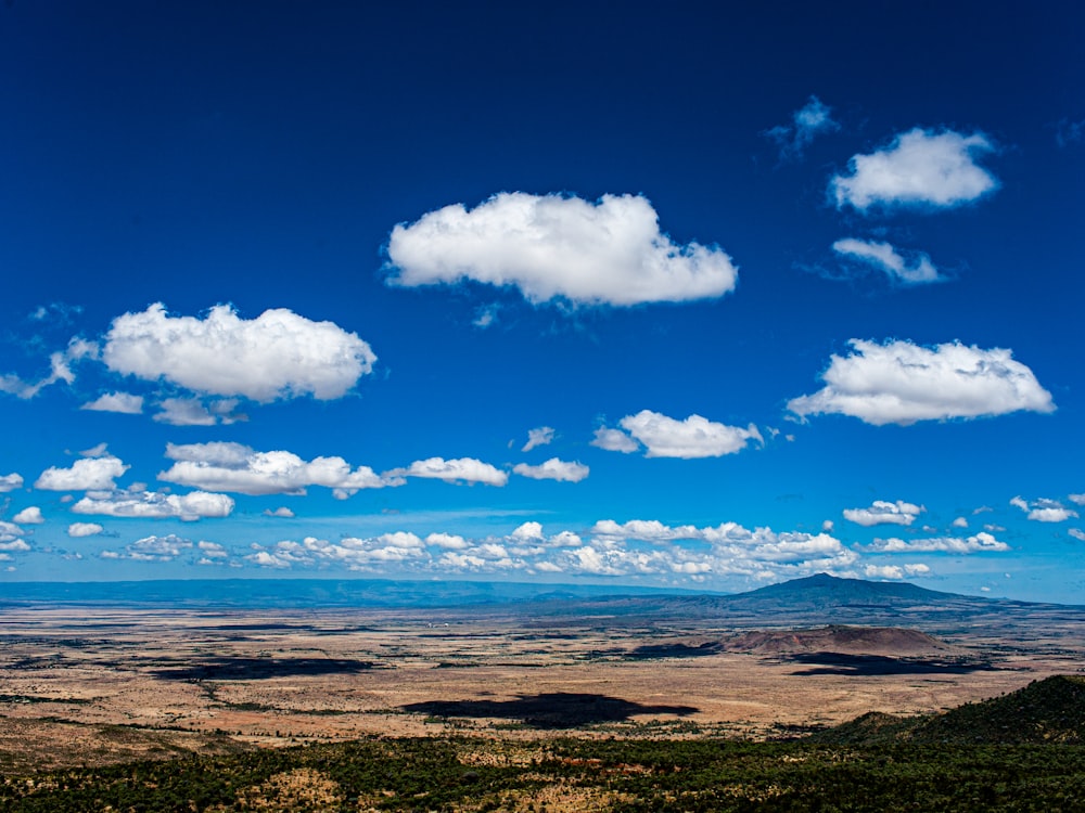 a view of a mountain range with clouds in the sky