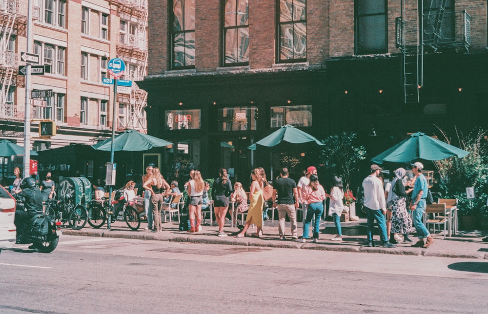 a group of people standing on the side of a road