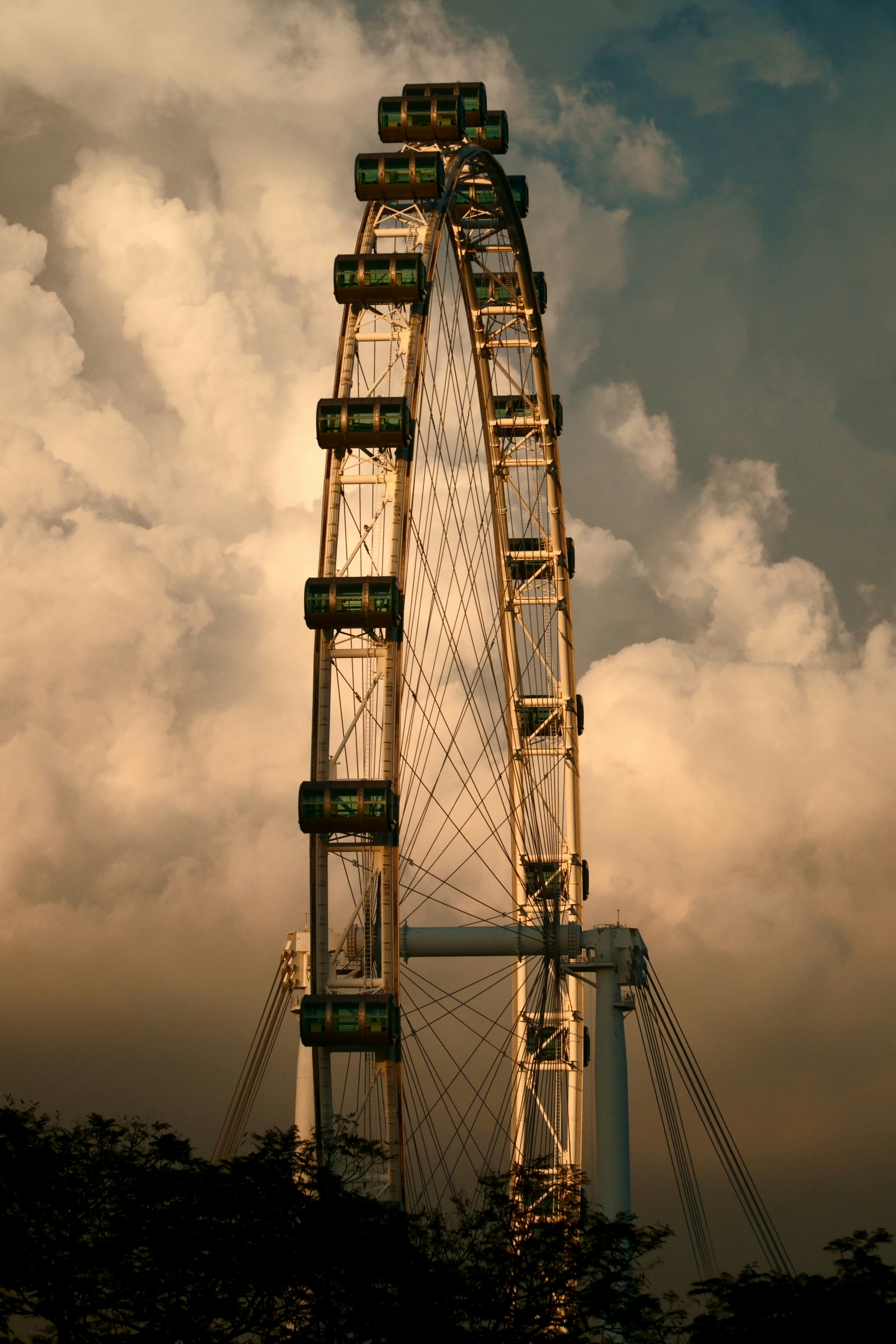 a ferris wheel in the middle of a cloudy sky