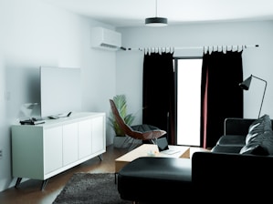 a black and white living room with a large window