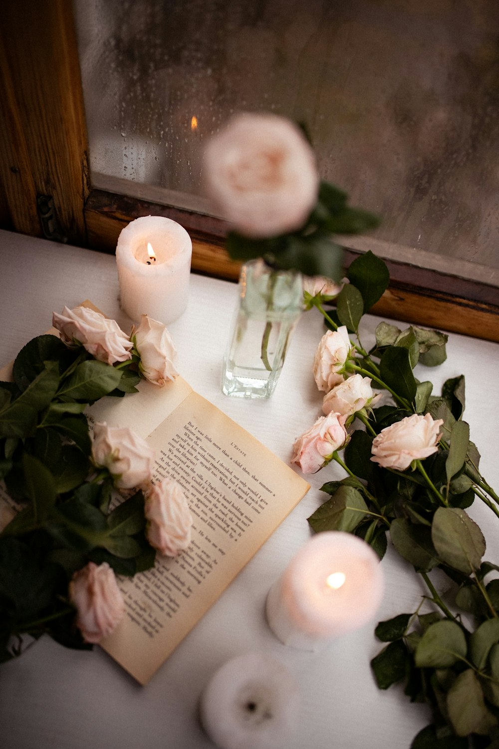 a book and some flowers on a table