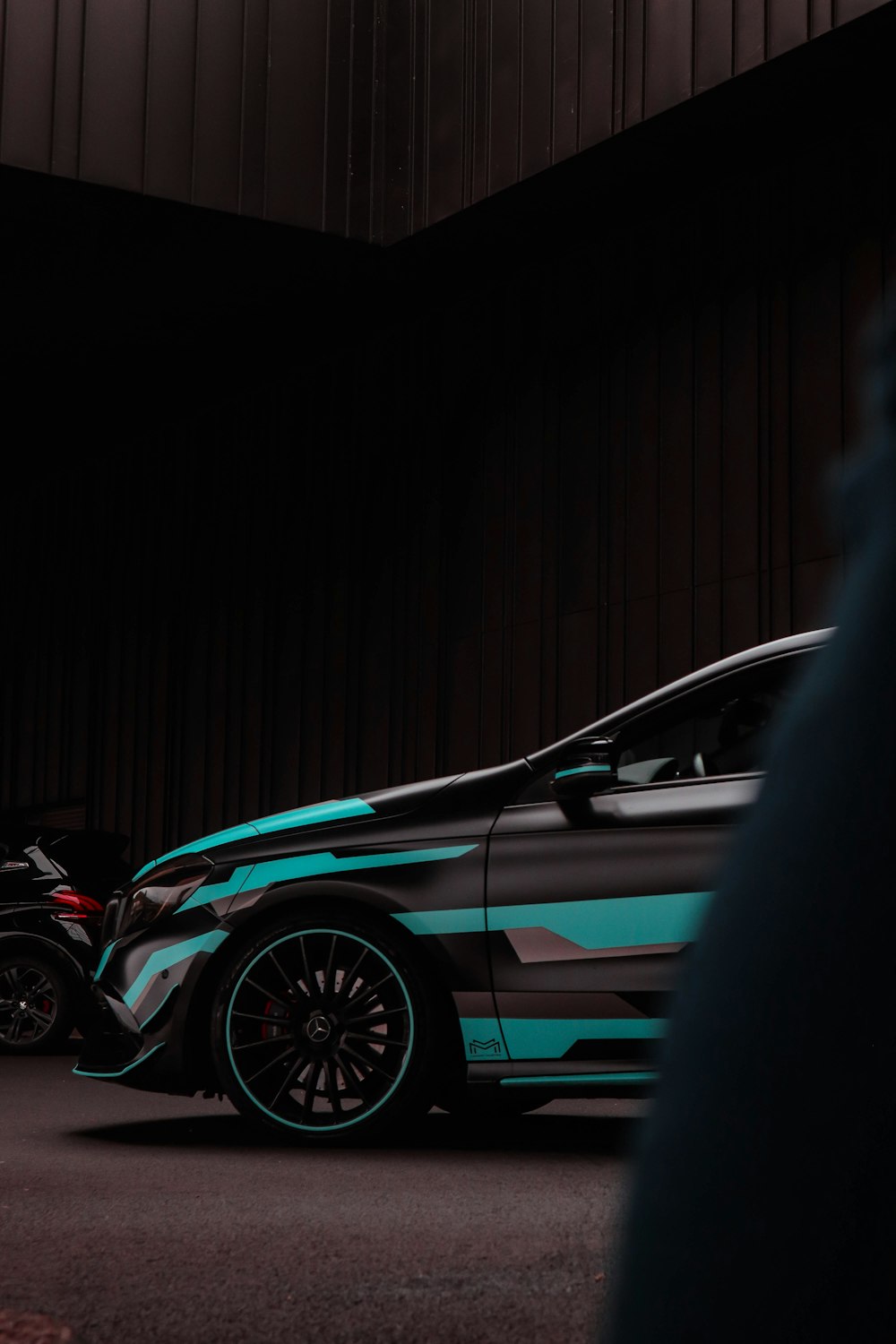 a blue and black car parked in a garage