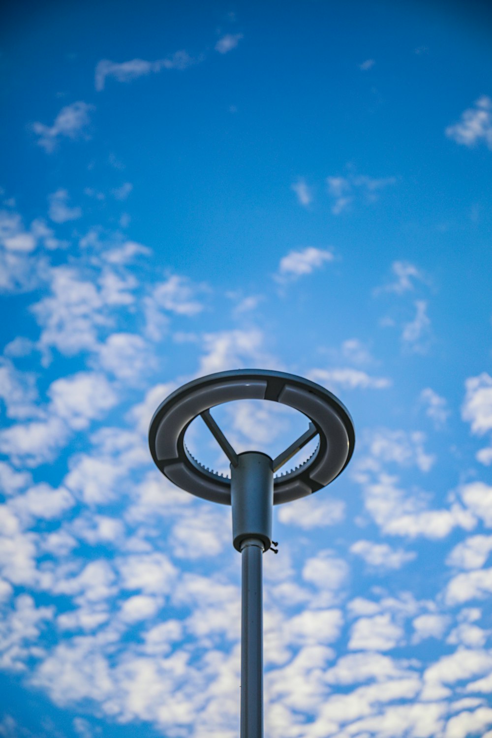 a street light with a blue sky in the background