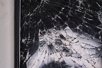 a broken mirror sitting on top of a white wall