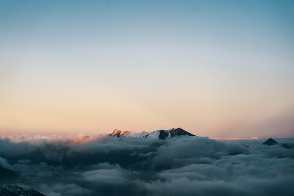 a view of a mountain covered in clouds