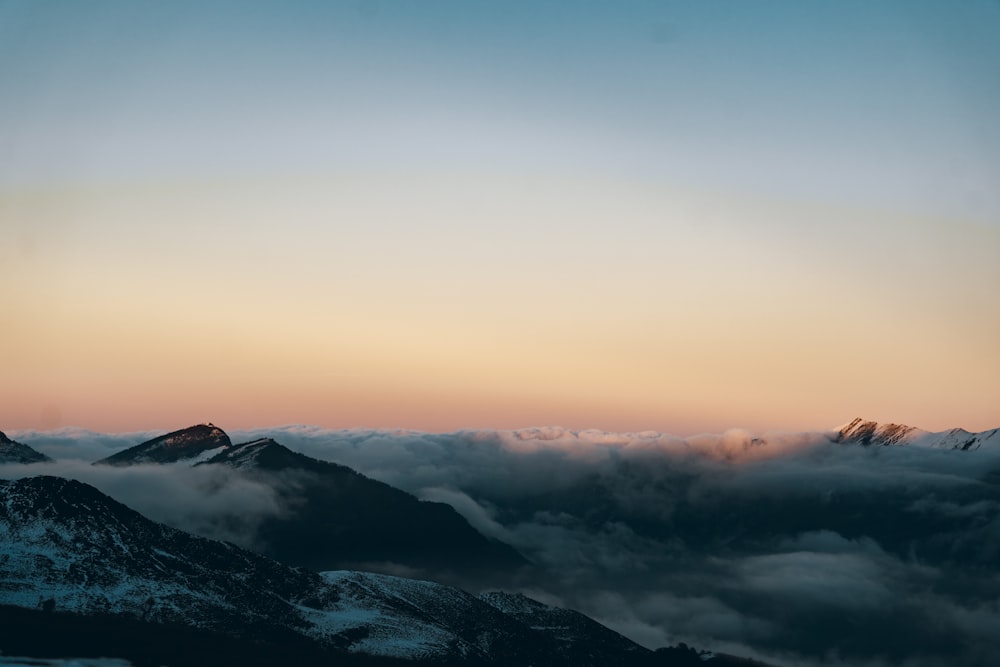 a view of the top of a mountain at sunset