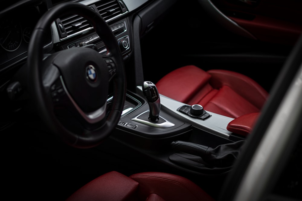 the interior of a car with red leather seats