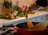 A happy home cook stirring a pot with fresh herbs and spices spread out nearby.