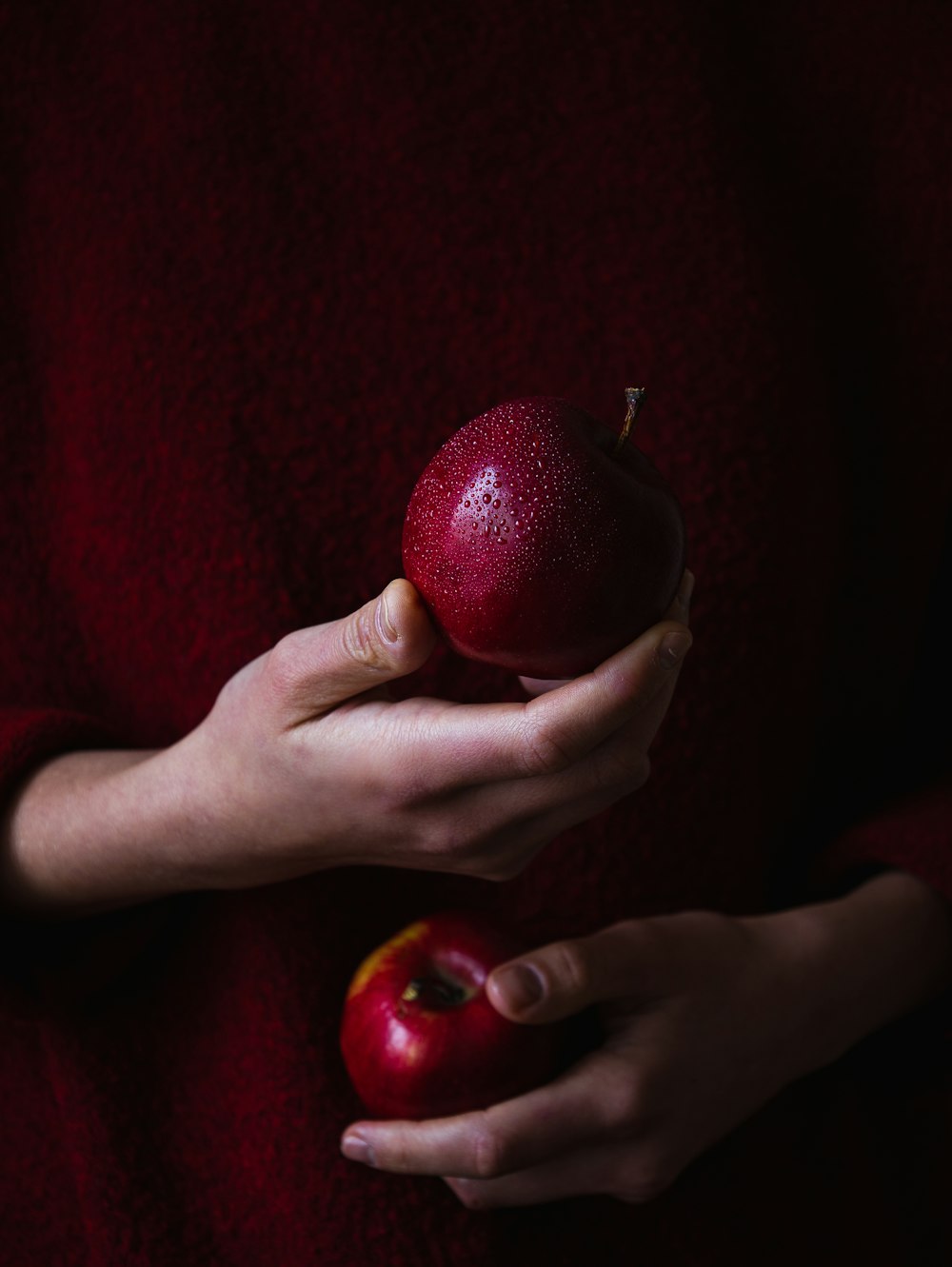 a person holding two apples in their hands