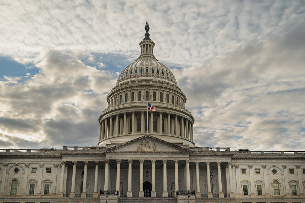 the dome of the u s capitol building under a cloudy sky