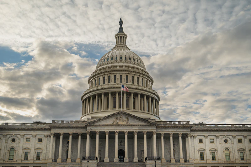 Capitol dome under a cloudy sky