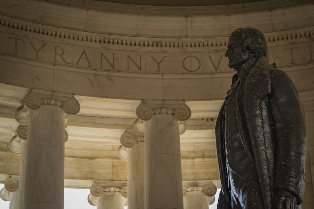 a statue of a man standing in front of a building