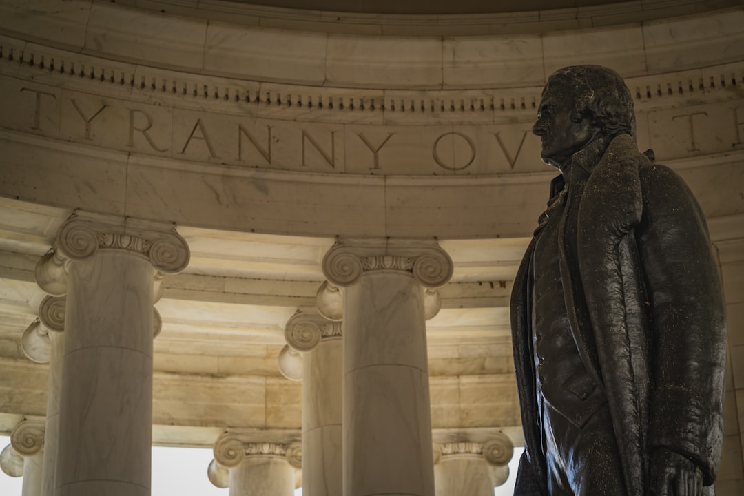a statue of a man standing in front of a building,