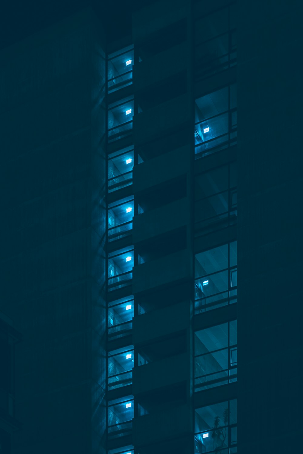 a tall building with many windows lit up at night