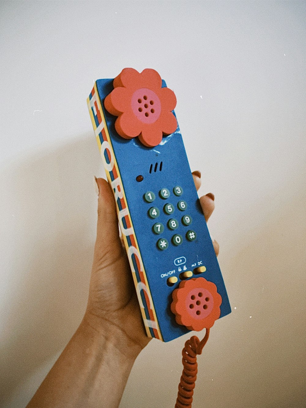 a person holding a remote control in their hand