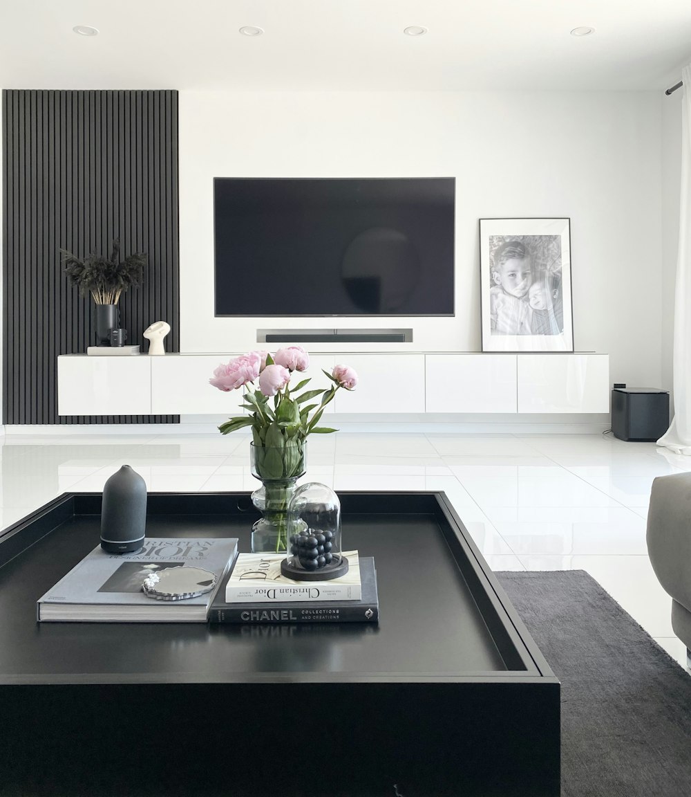 a black and white living room with a large tv