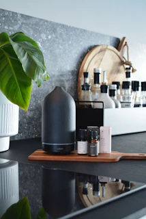 Minimalist kitchen counter featuring seh enhancer bottle next to fresh vegetables and herbs