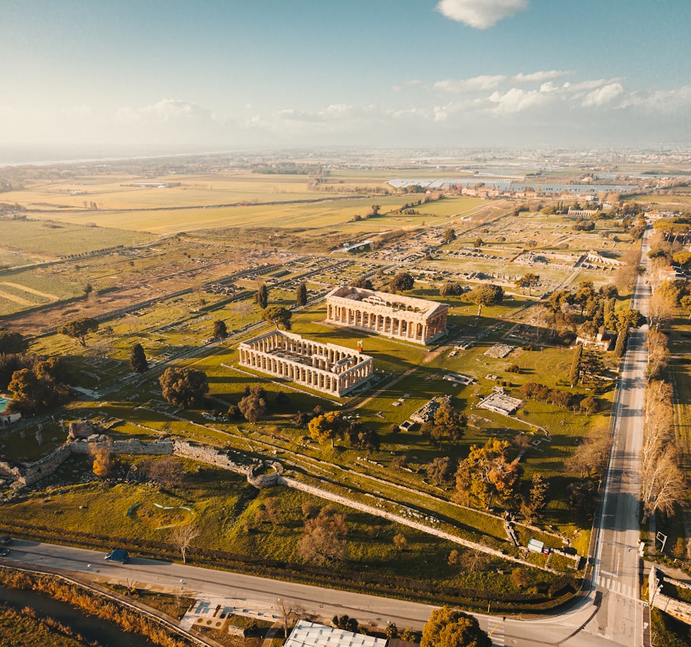 an aerial view of a large building in the middle of a field