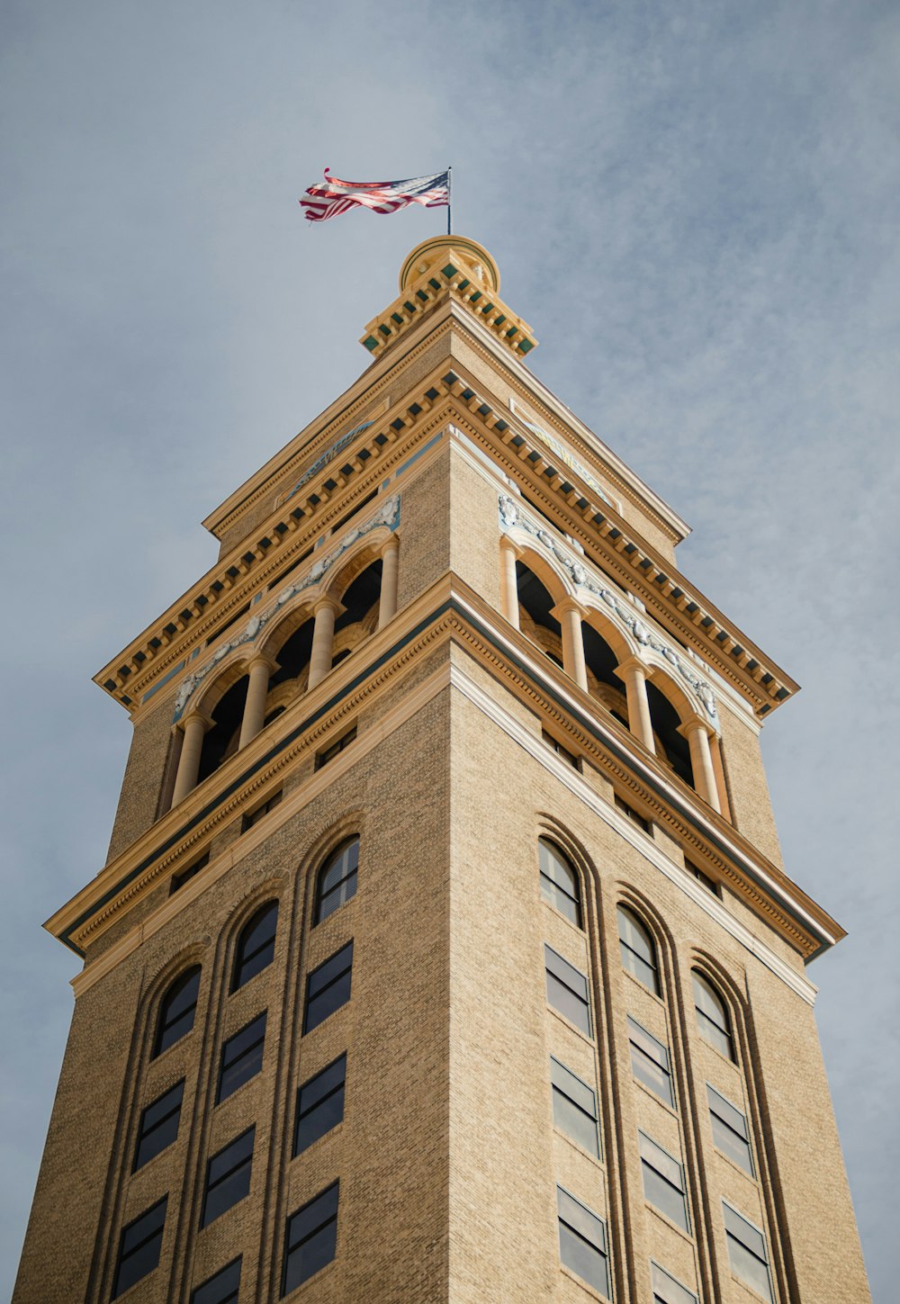 a tall building with a flag on top of it