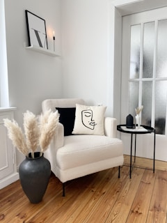 a living room with a white couch and a black table