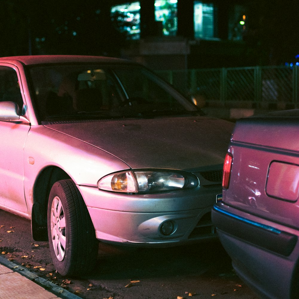 a pink car parked on the side of the road