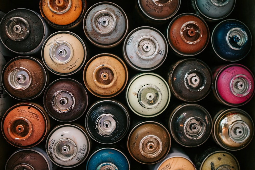 a box filled with lots of different colored cans