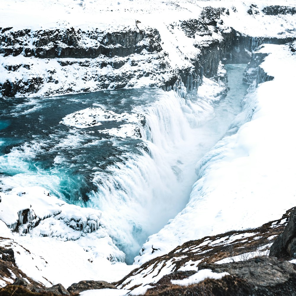 a man standing on top of a snow covered cliff