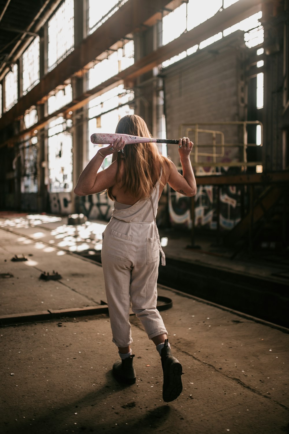 a woman holding a baseball bat over her head