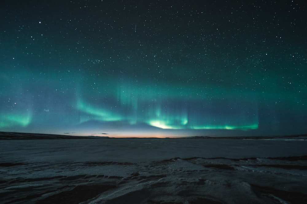 a green and blue aurora bore in the night sky