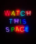 a neon sign that says watch this space