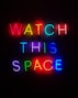 a neon sign that says watch this space