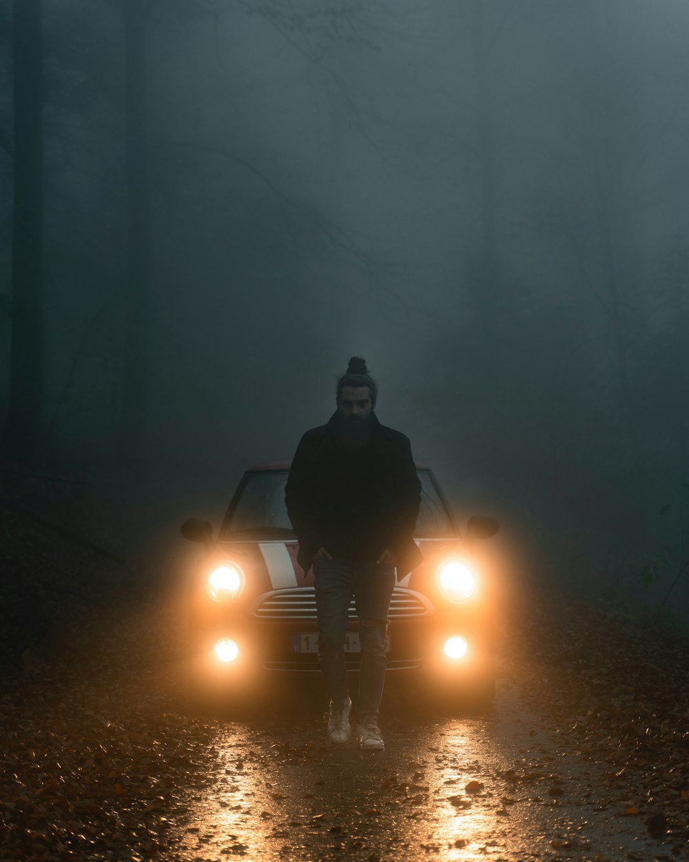 a person riding a motorcycle in the dark with headlights on