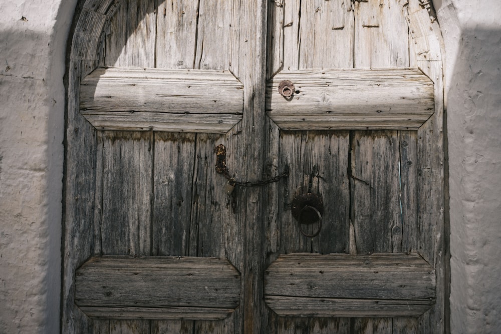 a close up of two wooden doors on a building