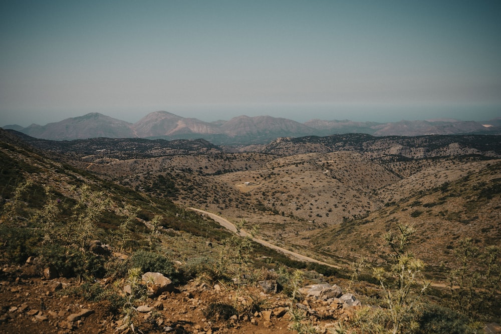 a dirt road winding through a mountainous area