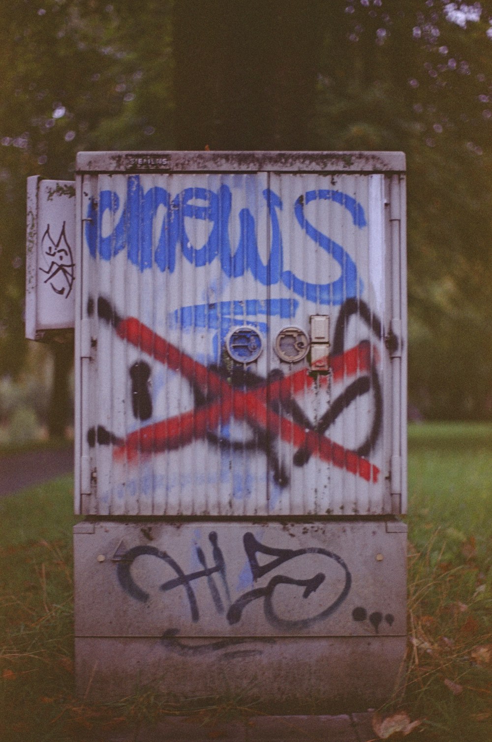 a metal box with some graffiti on it