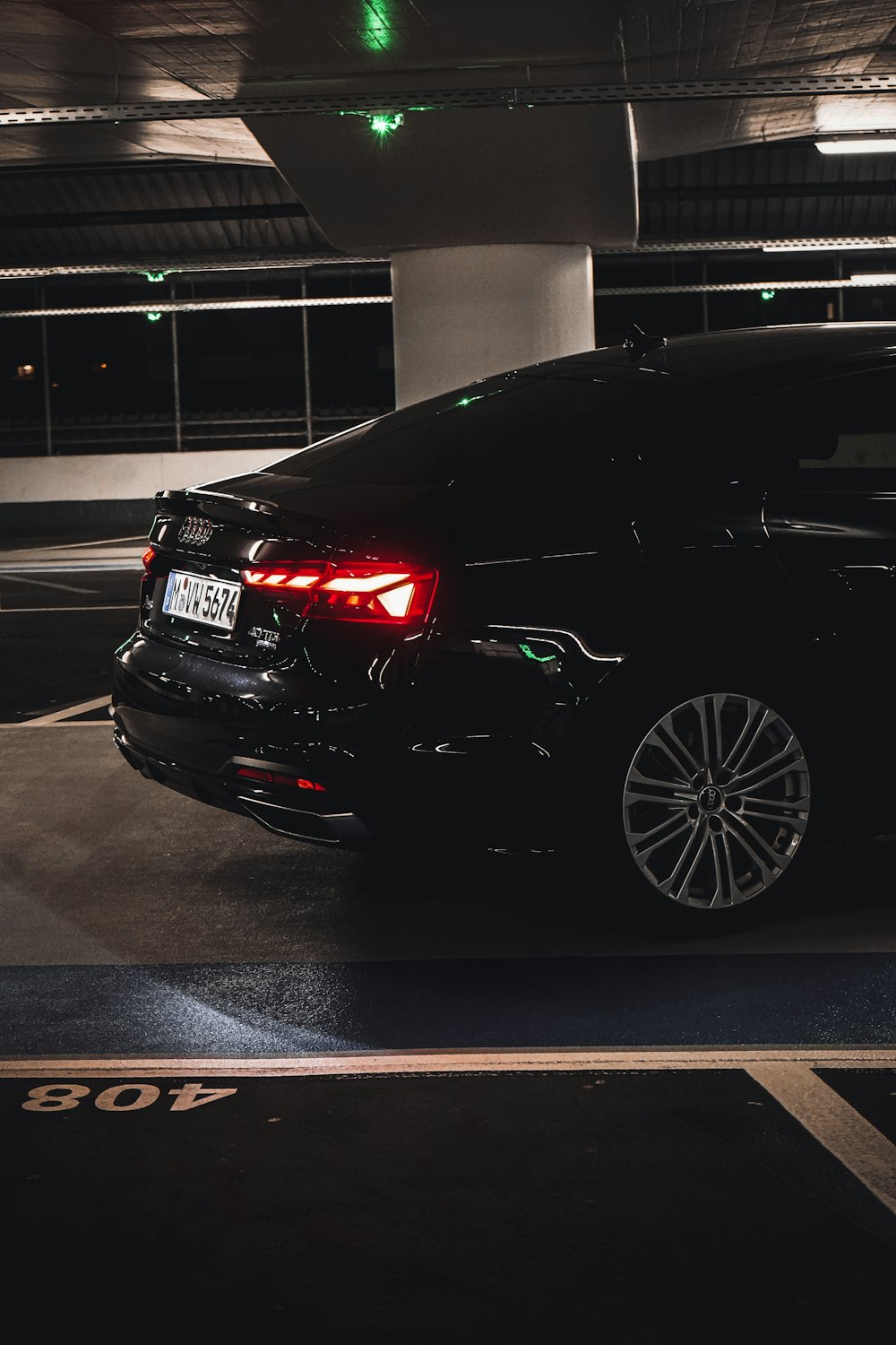 a black car parked in a parking garage