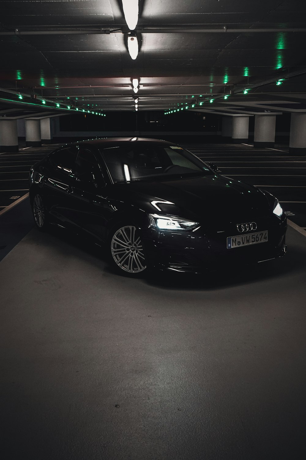 a black car parked in a parking garage