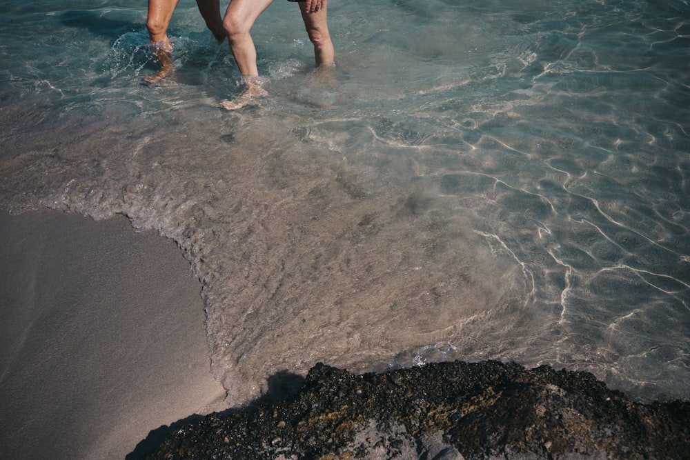 uma pessoa vagando na água na praia