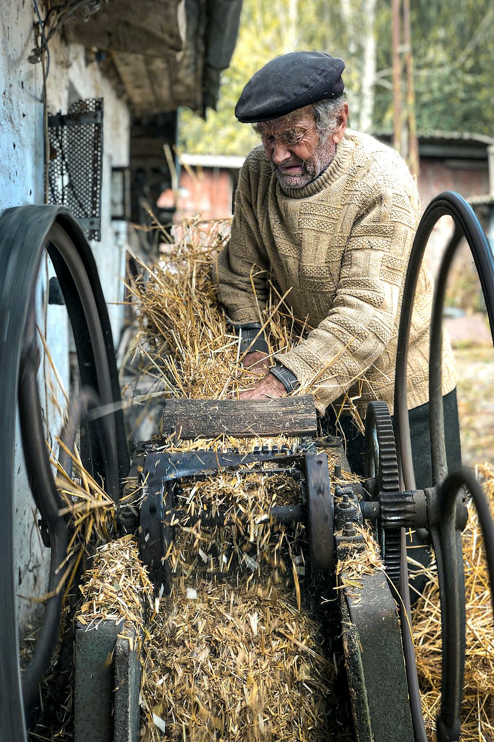 an old man is working on a machine