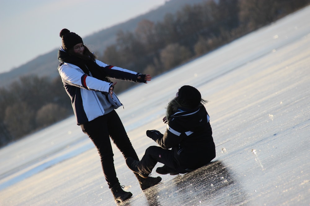 a man with a long beard standing next to a woman on a frozen lake