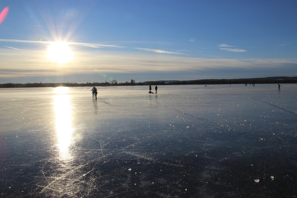 a group of people skating on a frozen lake