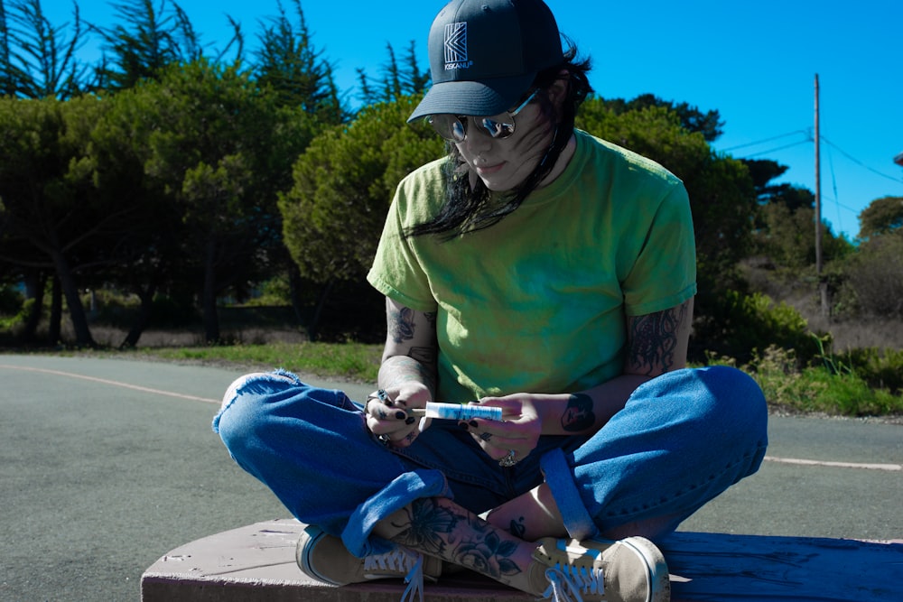 a person sitting on a skateboard on a street