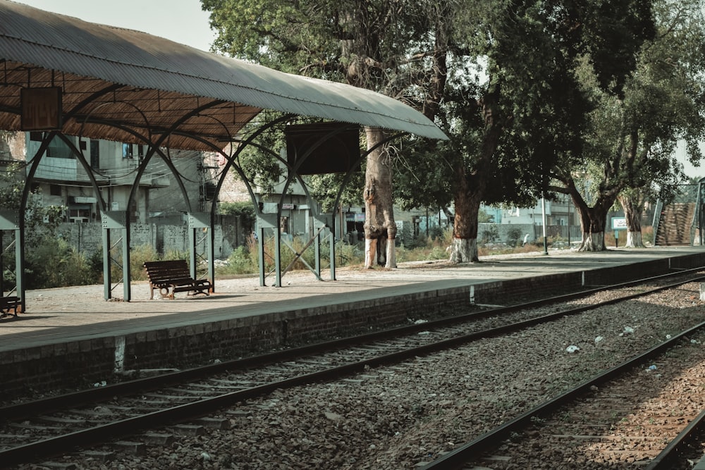 a train station with a bench on the platform