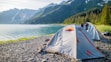 a tent pitched up on the shore of a lake